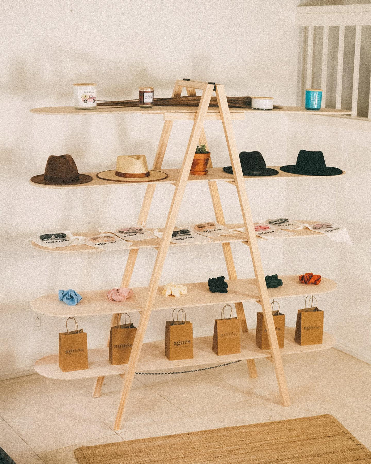 STANDRO LSD-5 five-tier wooden A-frame display with hats, packaged accessories, scrunchies and paper bags.
