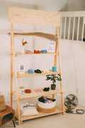 STANDRO EMS-3 portable wooden market display with a vertical rear frame, four shelves and a blank header board, stocked with accessories.